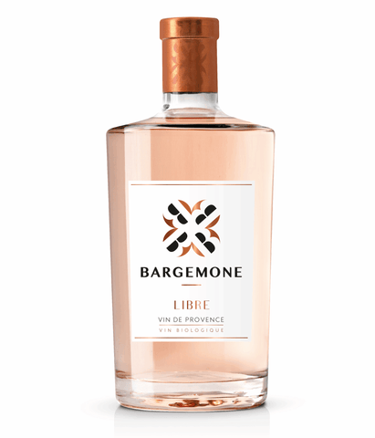 A bottle of BargeMone Libre Vin de Provence organic red wine, showing the pale pink liquid inside a clear glass bottle with a white label and a metallic copper-colored foil cap, set against a plain white background.