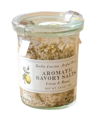 A glass jar of Bella Cucina Artful Food Aromatic Savory Salts in the Citrus & Fennel blend, featuring a white label with a yellow lemon illustration and a clear lid with a metal clip.