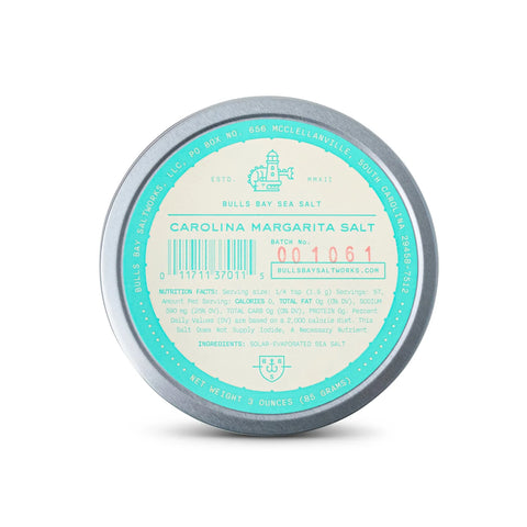 A round metal tin of Bull's Bay Sea Salt, specifically Carolina Margarita Salt, with a light blue and cream label, photographed on a clean white background.