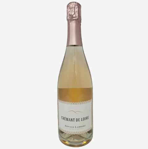 A bottle of Annaud Lambert Crémant de Loire sparkling wine with pale golden-amber liquid, a white label, and a metallic pink foil top, isolated on a light gray background.