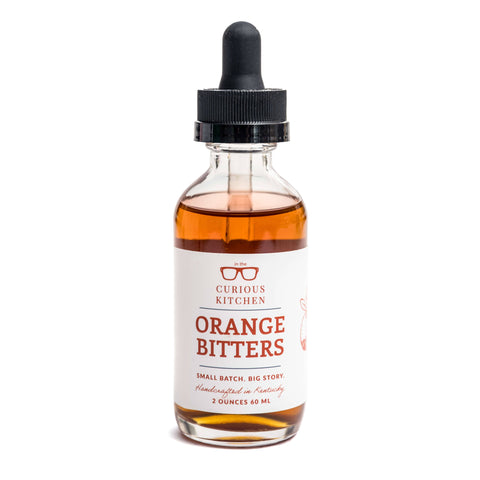 Bottle of Curious Kitchen Orange Bitters on a white background