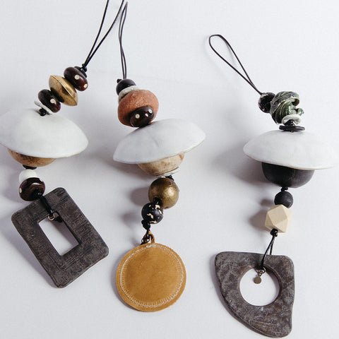 A collection of door charms in various designs, featuring natural and man-made materials, displayed against a white background.