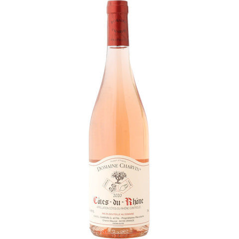 A bottle of rosé wine with a pale pink liquid, a cream-colored label reading 'Domaine Charvillès' and 'Cotes du Rhône', and a red foil seal at the top, shown on a plain white background.