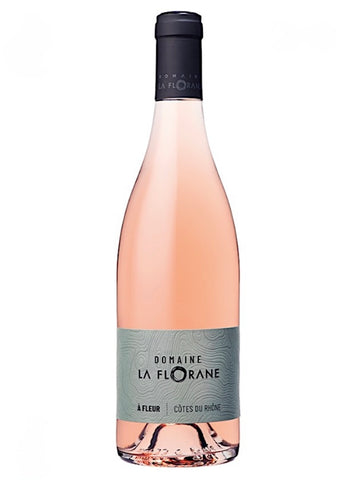 A bottle of rosé wine with pale pink liquid, a gray label reading 'Domaine La Florane', and a black capsule cap, isolated on a white background.