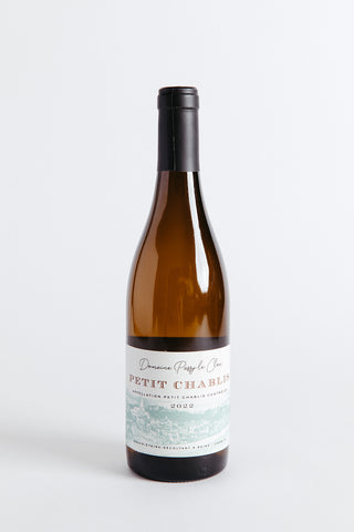 A bottle of Domaine Passy Le Clou Petit Chablis wine with a label showing the brand and the name of the wine.