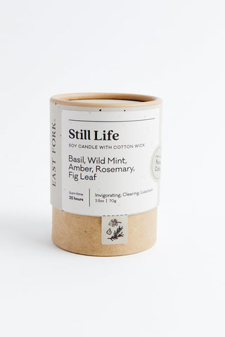 Candle packaging with 'Still Life' label on a white background