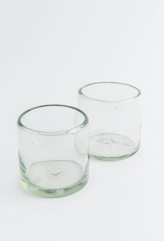 Two clear glass tumblers on a white background