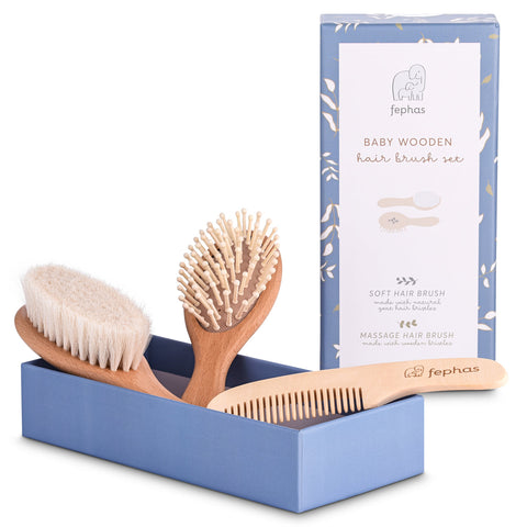 Set of baby wooden hairbrushes and comb with packaging on a white background