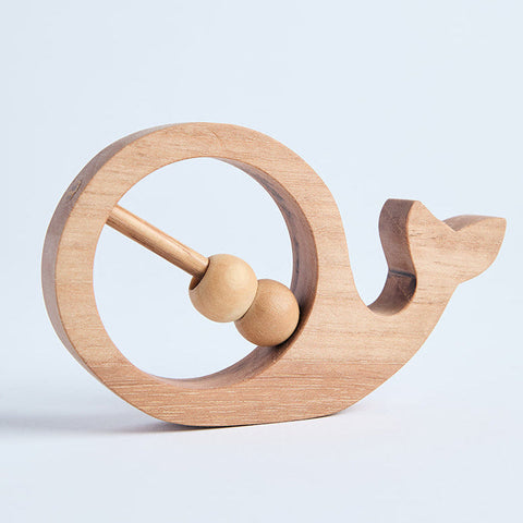 A wooden rattle toy shaped like a snail on a white background