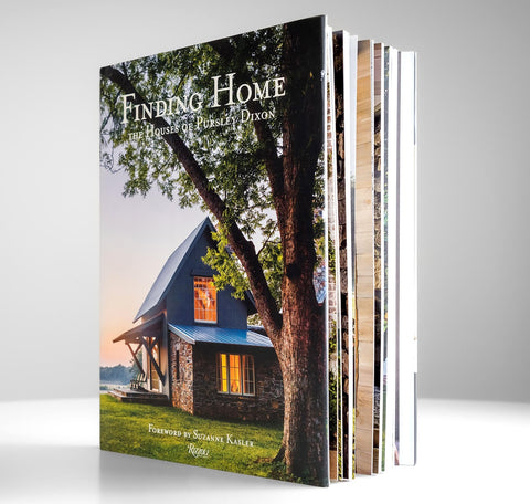A hardcover book titled "Finding Home: The Houses of Patricia Dixon" shown standing upright with several matching books fanned out behind it on a light gray background.