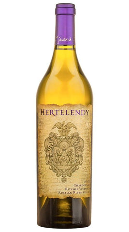 A bottle of Hertelendy Chardonnay from the Ritchie Vineyard, featuring a golden-yellow wine liquid, a textured beige label with a crest, and a purple foil capsule at the neck, set against a plain white background.