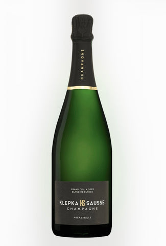 A bottle of Klepka & Sausse Champagne with a dark green glass body, black foil, and a black label with gold lettering, set against a plain white background.