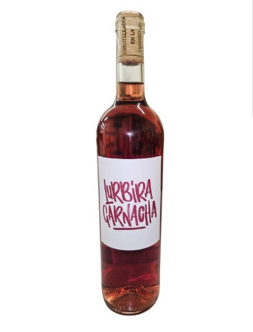 A bottle of Rosé wine with a white label reading 'LURBIRA CARNACHA' in red hand-drawn lettering, sealed with a cork, on a white background.