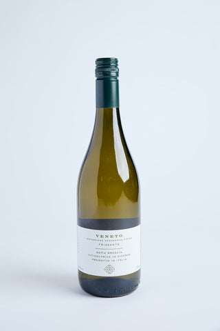 A bottle of white sparkling wine labeled 'Veneto' with text indicating the grape varieties and the region of Italy where it was produced.