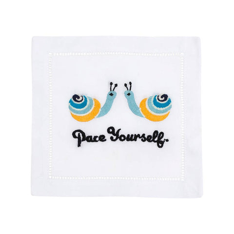 White napkin with embroidered snails and 'Pace Yourself' text on a white background