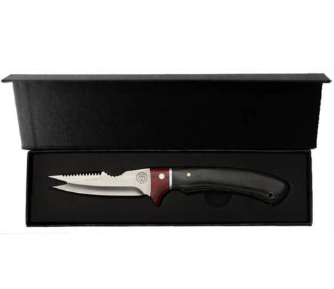 A fixed-blade knife with a silver serrated blade, a dark gray handle, and a reddish-brown bolster, presented inside an open black gift box on a white background.