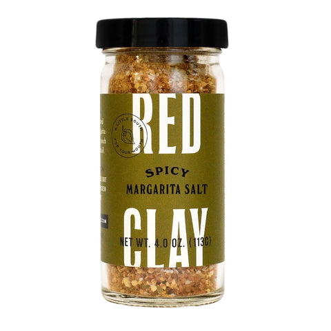 A jar of Red Clay Spicy Margarita Salt on a plain white background. The product is in a clear glass jar showing the coarse salt inside, with a black lid and a muted olive green label featuring bold white and black text.