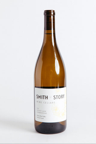 A bottle of Smith Story Olivet Lane Chardonnay wine with a white label on a clear background.