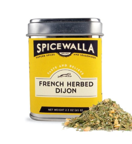 A tin of Spicewalla French Herbed Dijon spices with a yellow label and silver lid, shown next to a small pile of the dried herb and spice blend on a white background.