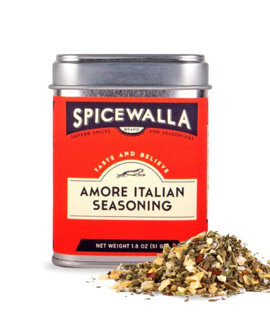 A tin of Spicewalla Amore Italian Seasoning with a red label and silver lid, shown on a white background with a small pile of the seasoning mix in front.