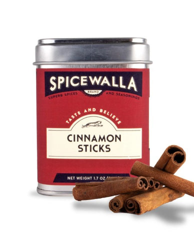 A tin of Spicewalla Cinnamon Sticks with several cinnamon sticks placed in front on a white background.