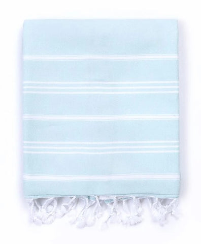 A light blue Turkish cotton towel with white horizontal stripes and fringed tassels along the bottom edge, displayed flat against a white background.