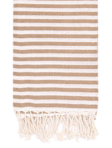 A striped cotton Turkish towel with cream and light brown horizontal stripes and fringed edges, shown flat against a white background.