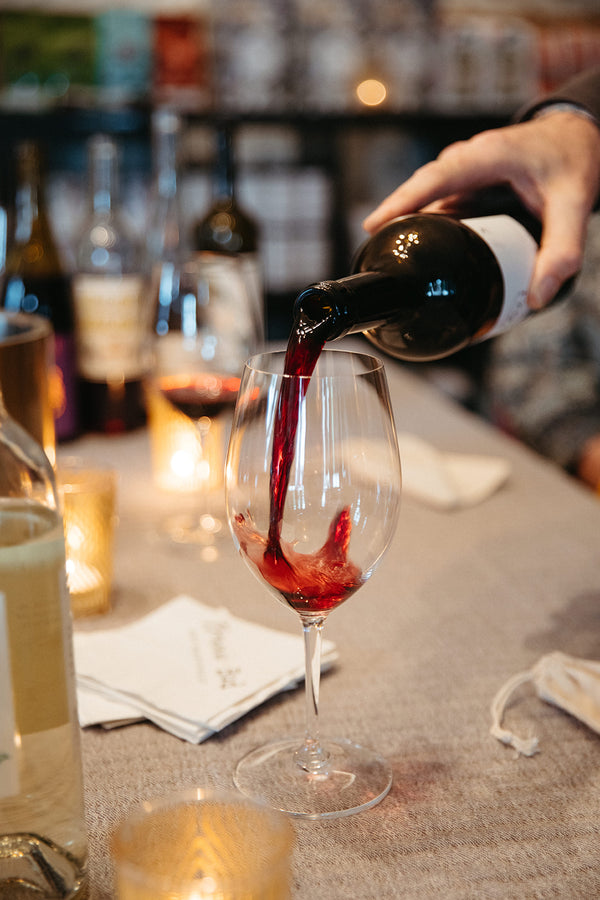 Pouring a small production bottle of wine in our Eastover Charlotte NC bottle shop
