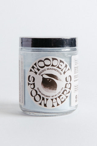 A jar labeled 'Wooden Spoon Herbs Magic Magnesium' on a plain background.